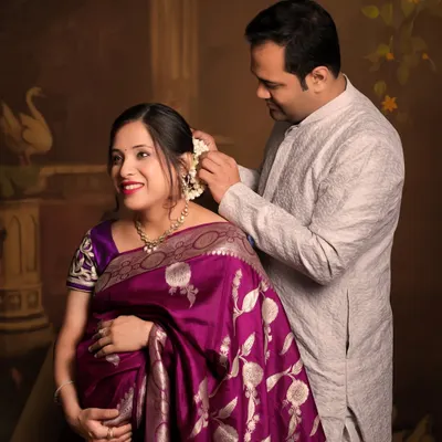 A beautiful, tender moment between a couple during their traditional maternity shoot. The husband placing flowers in her hair is a timeless gesture of love.