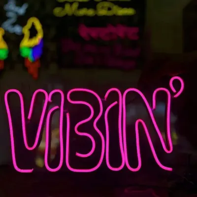 Add a cool, modern touch to your party with a custom neon sign. This pink "VIBIN" sign is perfect for setting the mood at any celebration and is available at a budget-friendly rate.