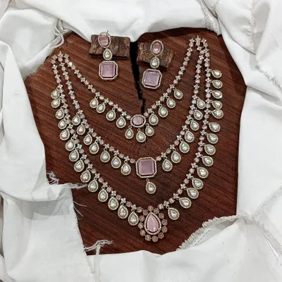 A beautiful layered necklace set in soft pink, perfect for a modern and feminine look.