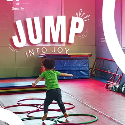 This is what it's all about: jumping into joy! Here, a child navigates a fun obstacle course with hoops, building coordination and having a great time.
