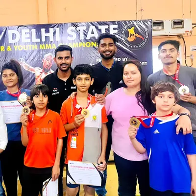 Our team celebrating a big win at the Delhi State MMA Championship 2024. We brought home 8 gold medals, 1 silver, and 1 bronze, along with the first prize trophy. This picture shows the joy and pride of our young champions and their coaches.