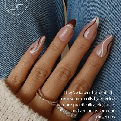 This almond-shaped set features a neutral base with elegant, free-flowing swirls in brown and white. It's a perfect example of practical, elegant, and versatile nail art.
