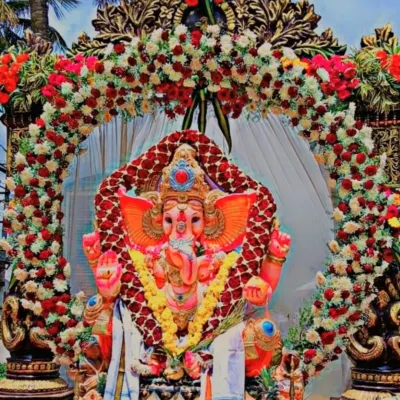 We pour our hearts into Ganesha Chaturthi celebrations. This grand idol setup features a dense, custom-made floral arch with thousands of fresh roses and chrysanthemums, creating a divine centerpiece for the festival.