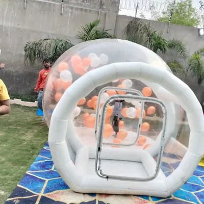 This is our bubble house with an entrance tunnel. It's a safe, enclosed space where kids can play inside a giant clear dome, often filled with balloons.