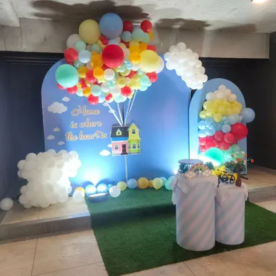 A whimsical housewarming party theme inspired by the movie "Up," with a balloon-lifted house prop.