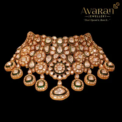 A magnificent Kundan and Polki choker, showcasing intricate floral motifs and uncut stones. This piece is a testament to traditional craftsmanship.