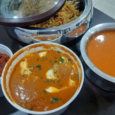 A comforting North Indian meal ready for delivery. This order included a rich paneer gravy, a flavorful biryani, and tomato soup for a small get-together.