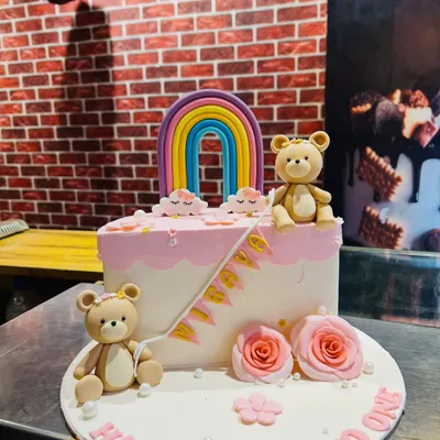 A sweet "Half way to one" cake for a 6-month celebration. This design features cute teddy bears, a colorful rainbow, and delicate pink roses.