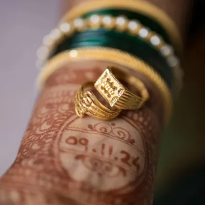 The little things tell a big story. This creative detail shot places the engagement rings over the wedding date written in henna, a unique and personal way to remember the beginning of your forever.