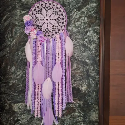 Chasing pastel dreams and cozy vibes. This floral dreamcatcher in shades of lavender and lilac, adorned with feathers, is perfect for boho home decor and makes a magical gift.