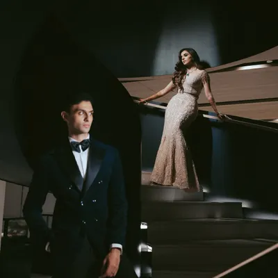 A masterpiece of light and shadow. We used this modern spiral staircase to create a dramatic, high-fashion portrait that feels both architectural and deeply romantic.