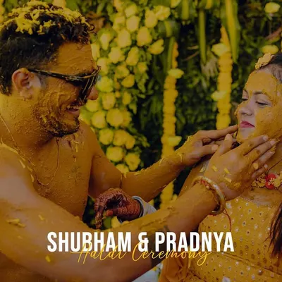 The Haldi ceremony is all about joy and color. This shot captures the couple sharing a fun, intimate moment while covered in turmeric paste.