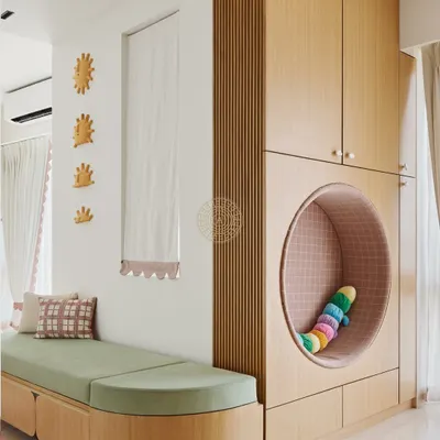 This reading nook is one of my favorite features in this girls' room. The wardrobe includes a cozy, circular cutout perfect for curling up with a book, and the long green bench provides extra seating and storage.