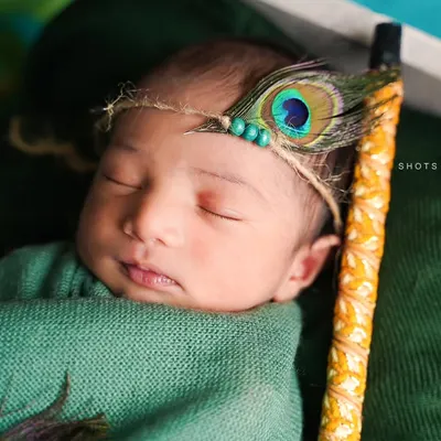 A close-up of a sweet, sleeping 6-day-old newborn. We focus on capturing these peaceful moments and delicate features during our at-home newborn sessions.