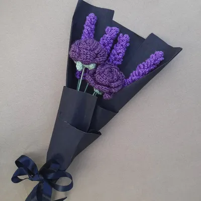A bouquet of deep purple crochet lavender and roses, wrapped in navy paper and tied with a matching satin ribbon. This style is great for a more modern or classic look.