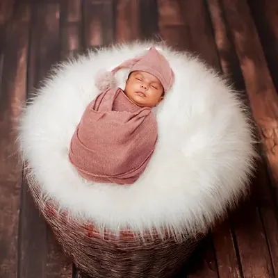 A perfectly swaddled newborn is the picture of peace. I use soft, comfortable wraps and a cozy basket to create these classic, womb-like poses that you will cherish.
