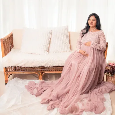 Simple, elegant, and minimal, that's our style. This mother-to-be looks absolutely radiant in a flowing pink gown, creating a soft and dreamy maternity portrait.
