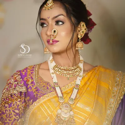 A classic Maharashtrian bridal portrait. The look features a beautiful yellow and purple Paithani saree, traditional jewelry including the Kolhapuri saaj, and makeup that highlights the bride's natural glow.