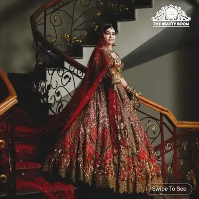 A full view of a majestic bridal look I created. The dramatic red lehenga and grand staircase setting called for equally regal makeup and styling, ensuring she was the center of attention.