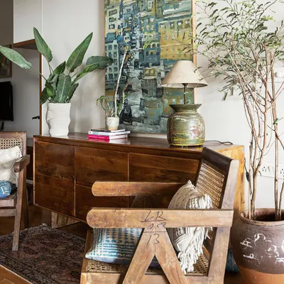 This living space from our 'Reweave Stories' project features a collection of modernist chairs and repurposed heirloom furniture. We believe in giving old pieces new life, weaving the client's personal history into the fabric of their home.