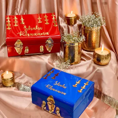My "Shahi Khazana" or royal treasure trunks are designed for the most special festive gifting. Available in vibrant red and royal blue, they are adorned with golden diyas to capture the essence of Diwali.
