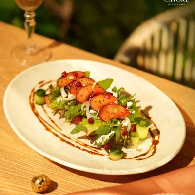 A refreshing start to the evening. This salad features fresh strawberries, crisp greens, and pomegranate seeds, all brought together with a light dressing and balsamic glaze for a balance of sweet and tart notes.