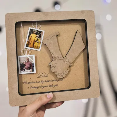 This custom frame was a special gift for a father. I replicated a photo of a father holding his daughter's hand in a wooden cutout, and added mini polaroids and a heartfelt message to complete the memory box.