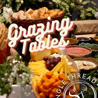 My grazing tables are designed to be inviting and layered. This one features a beautiful assortment of cheeses, fruits, and breads, set against a backdrop of fresh flowers.