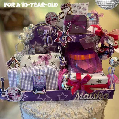 A popstar-themed hamper for a 10th birthday, designed to feel like a stage. I used a custom arch, disco balls, and personalized elements like the name 'Maisha' to create a gift with big energy for a big birthday.