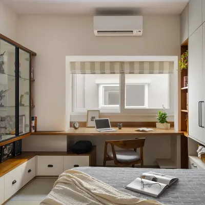 This home office in our 'Palaash' project is designed for both work and play. It features a deep desk for productivity, a proud display for a superhero collection, and a hidden Murphy bed that folds down for guests.