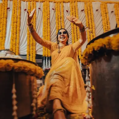 The bride, full of energy and joy, dances during her Haldi ceremony. We capture the celebration in its most candid and lively form.