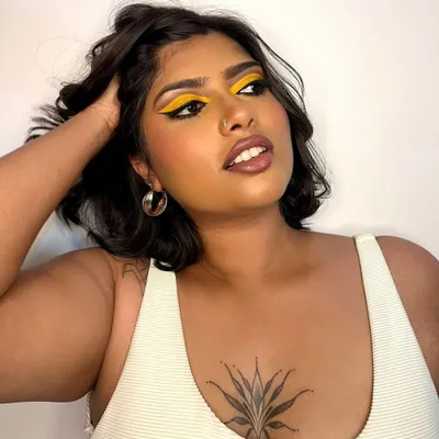 A bold and graphic look featuring a vibrant yellow eyeshadow. This kind of creative makeup is perfect for editorial shoots where you want to make a statement with color.