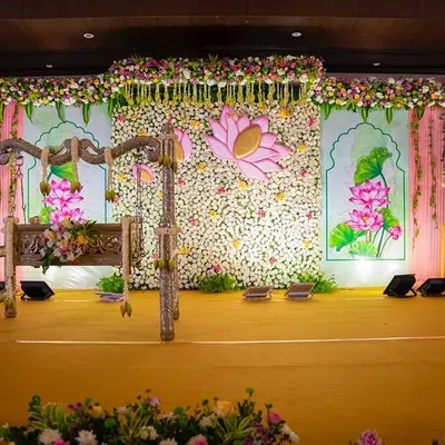 A full view of the 'Lotus Love' naming ceremony stage. The combination of a dense floral wall, hand-painted lotus panels, and a traditional swing creates a setting that is both grand and deeply symbolic.