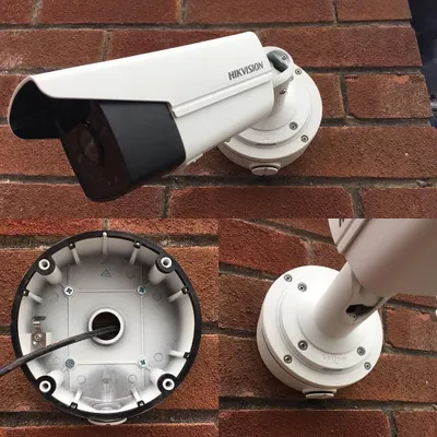 A closer look at a professional Hikvision camera installation on a brick wall. We use a junction box to protect all wiring from weather and tampering, ensuring a clean look and long-term durability for your security system.