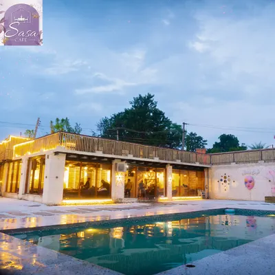Welcome to your private escape. This is the view of Sasa Cafe from our poolside area at dusk, just as the lights start to create that magical glow. It’s a space I designed for you to leave the city chaos behind and just chill.