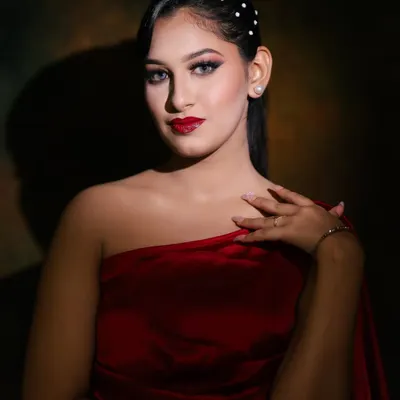 A classic glamour look featuring a bold red lip and dramatic winged eyeliner. The lighting creates a beautiful shadow, highlighting the model's features. This is a timeless look every artist must master.