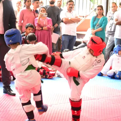 A young student demonstrates a precise side kick during a competitive match. Our tournament training focuses on timing, accuracy, and maintaining composure in the ring.