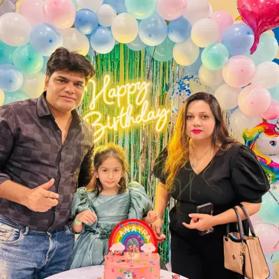 A happy family celebrating their daughter's 4th birthday with a unicorn cake. It's a joy to host these special family milestones.