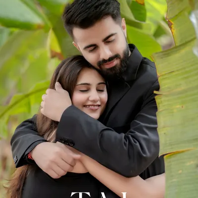 A warm and loving embrace surrounded by lush greenery. The couple's serene expressions and close hug create a portrait that is full of peace, comfort, and deep affection.