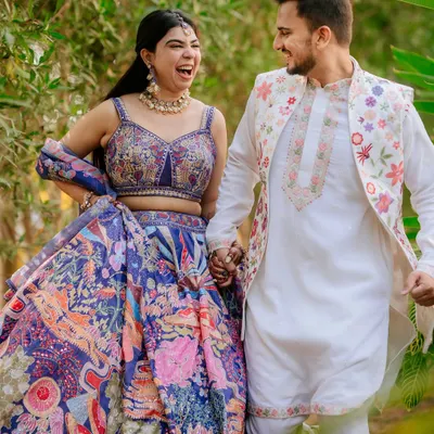 A moment of pure joy and laughter during a pre-wedding shoot. The couple's vibrant, coordinated outfits by Seema Gujral add a beautiful splash of color.