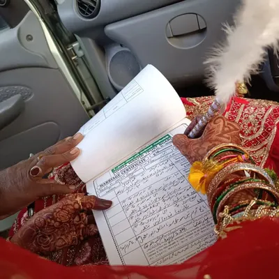 Being part of the 'Qubool Hai' moment is the greatest honor. Here, a bride's henna-adorned hands sign her marriage certificate, marking the beginning of a new journey.