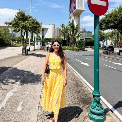 A full view of the custom yellow gingham check skirt and top co-ord set. This outfit is perfect for a sunny day out, a vacation, or a casual brunch, offering a cheerful and stylish look.