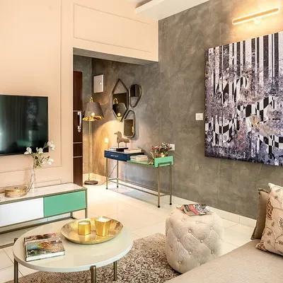 A monochrome painting of a horse, rendered in an abstract geometric style, hangs on a textured grey wall. The piece acts as a focal point in this chic living room, tying together the room's modern aesthetic.