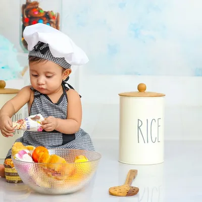 This little chef is carefully inspecting the ingredients. My chef-themed shoots are filled with fun props for your culinary artist to explore.