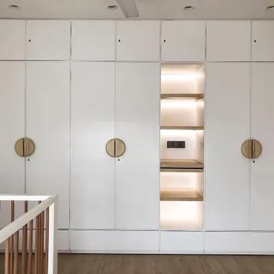 This large, modern wardrobe provides incredible storage for a growing child. I designed it in a clean white finish with a beautifully lit central niche for displaying special toys or books. The round wooden handles are easy for little hands to use.