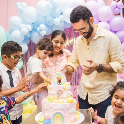 The cake cutting ceremony is a special moment for the whole family. Look at all those happy faces!