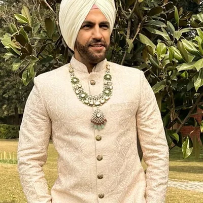 A close-up of a Sikh groom's look. I paired this elegant ivory sherwani with a magnificent multi-layered emerald and polki necklace, creating a look of pure regality.