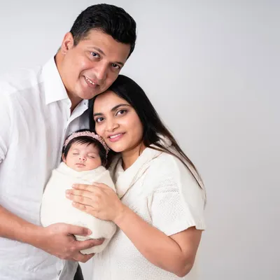 A beautiful first family portrait. The love and happiness in this photo are palpable. This is a memory this family will treasure forever.