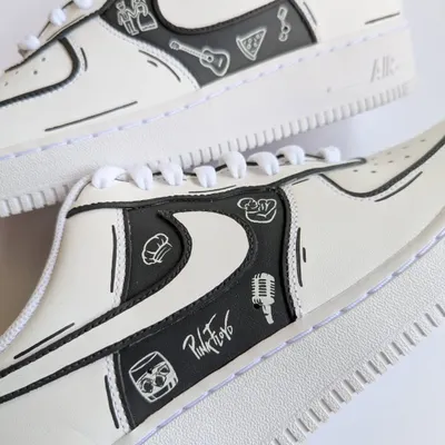 A close-up of a monochrome doodle AF1, telling the story of a client who is a singer, gamer, and foodie. Every icon represents a piece of their life.