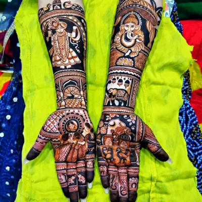 A divine masterpiece for a bride's new beginning. This design features detailed portraits of Radha-Krishna on one arm and Lord Ganesha on the other, surrounded by intricate traditional patterns.